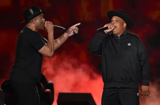 US rappers Joseph Simmons (R) and Darryl McDaniels (L) from Run-D.M.C. perform during the Hip Hop 50 Live concert, marking the 50th anniversary of the birth of hip hop, at Yankee Stadium in the Bronx borough of New York City on August 11, 2023. A genre, a culture and a lifestyle all at once: hip hop has traveled from the block party to the billionaire's club, soundtracked protest and celebration, and asserted seismic influence over the course of pop. The reigning music style evolved in rapid, anarchic ways, rocking the industry establishment that long resisted its power, and fully embodying the culture of youth even as it grew. This year hip hop turns 50, an anniversary that's offered its elders, its fans and the city that birthed it a milepost to reflect on its cultural weight. (Photo by ANGELA WEISS / AFP) (Photo by ANGELA WEISS/AFP via Getty Images)